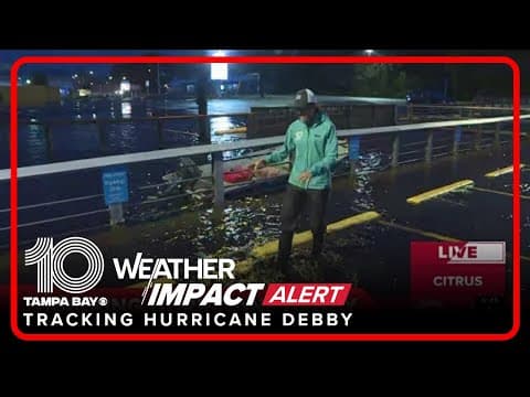 Water floods parking lot in Crystal River after coming up over the sea wall during Hurricane Debby