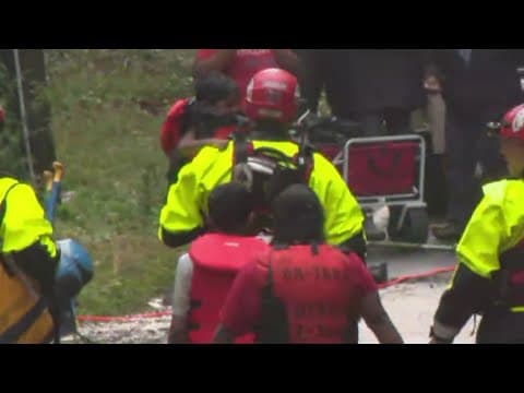 Mom, 2 kids rescued from their car during flooding