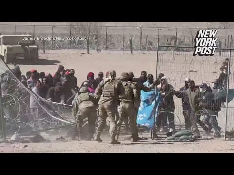 Migrants in custody after rushing fence