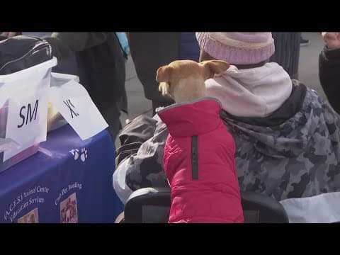 Homeless individuals receive blankets and sweaters for their pets