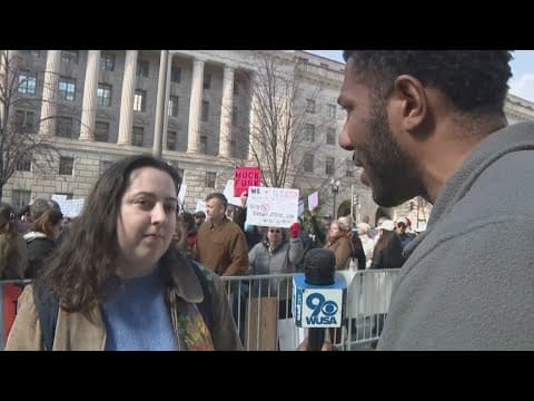 Fired USAID workers walk out to cheering crowd