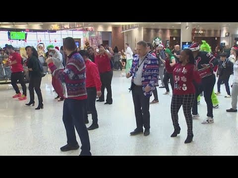 Flash mob entertains passengers at Bush Airport on busy travel day