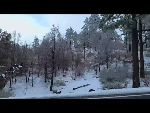 Visitors gather at Mountain Laguna as snow blankets the mountains