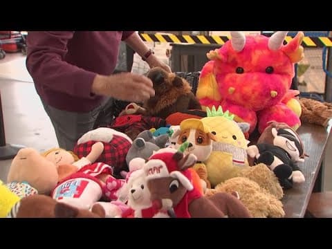 Volunteers hand out stuffed animals to kids at Mid-Ohio Food Bank