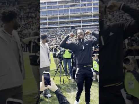 Travis Hunter and Shedeur Sanders watch as numbers are retired at Colorado stadium