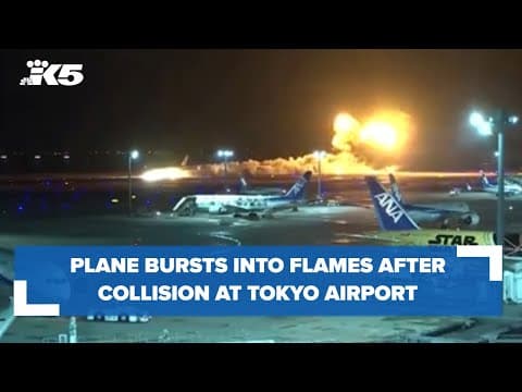 Plane bursts into flames after collision in Japan
