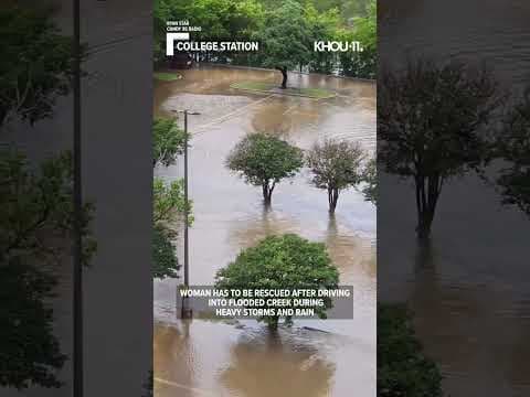 Woman drives into overflowing creek after severe storms #shorts #weather