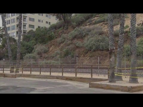 Landslide shuts down commuter train service after debris is seen rolling down hillside