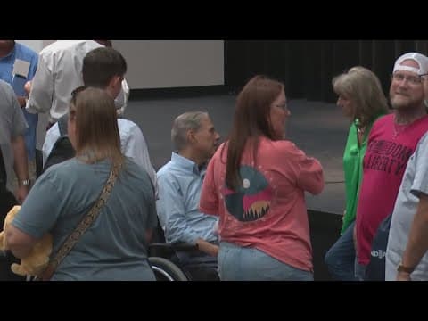 Abbott hands out checks using money raised at George Strait benefit concert