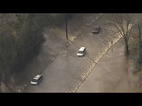 Cars stranded on flooded road on FM 2920 near Mueschke