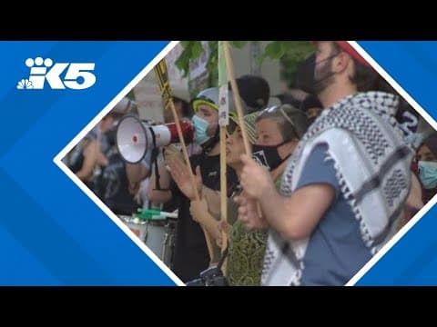 Protesters greet President Joe Biden upon his arrival in Seattle