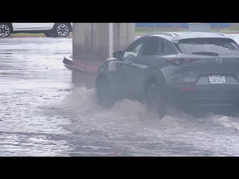 Rain floods Mission Valley roads, snow falls in local mountains on Monday