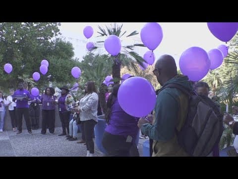 Families, advocates and survivors gathered to mark Domestic Violence Awareness Month