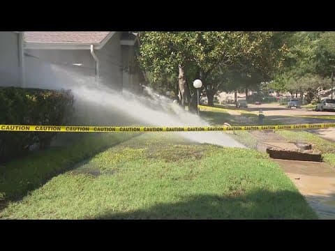 Water shoots out from under sidewalk in west Houston neighborhood