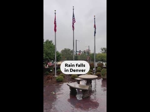 Rain falls in downtown Denver as cold front hits Colorado