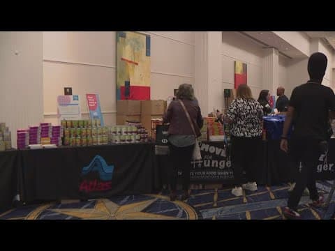 Conference attendees pack meal kits for local families | Get Uplifted