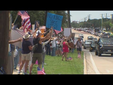 Protesters gather along the roadside in Flower Mound for 'No Kings' rally