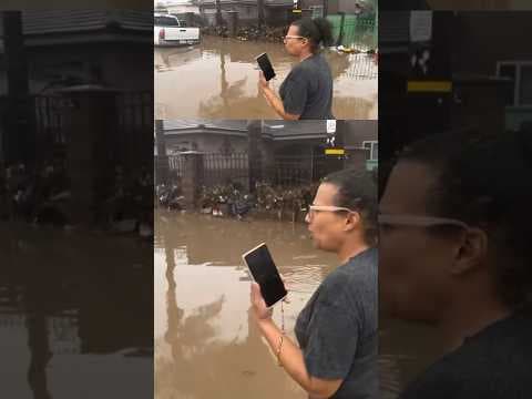 San Diego woman wades through flood waters to find her car that was swept away during storm