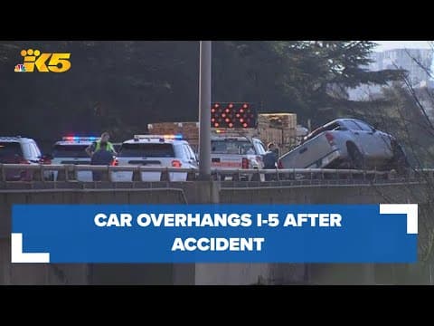 Car overhangs edge of I-5 in Seattle after wreck