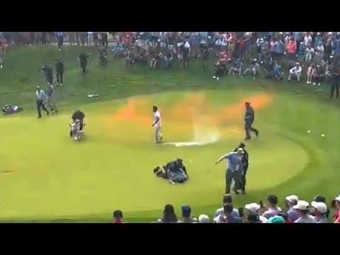 VIDEO: climate protesters run onto 18th green and spray powder, delaying finish of PGA Tour event