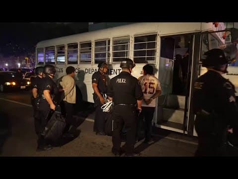 Detained protesters loaded onto a bus in Los Angeles