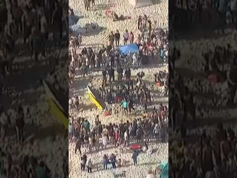 Lifeguards work to rescue girl trapped underneath sand at Mission Beach