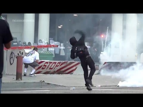 Police and protesters clash outside federal detention center in LA after ICE raids