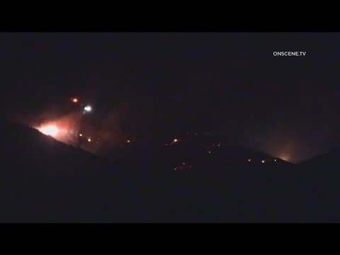 Firefighters respond from ground and air to brush fire burning in Rancho San Diego
