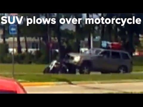 Distracted driver in SUV plows over motorcycle; cyclist incredibly on has minor injuries