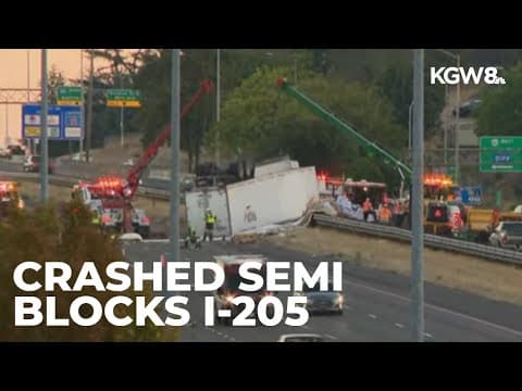 Crews working to clear overturned semi-truck off I-205