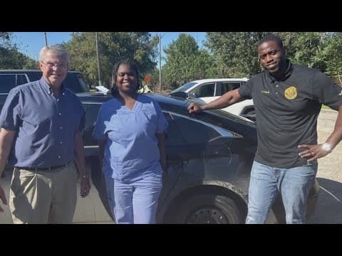 Council member Freddie King and WWL photographer help woman with flat tire