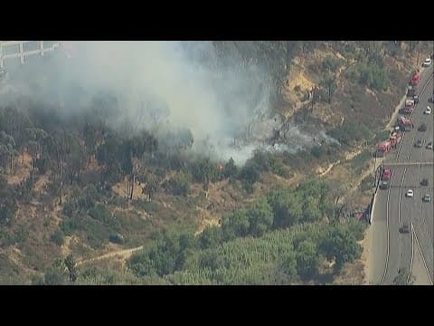 Chopper 8 aerials above brush fire near I-15 near Home Avenue