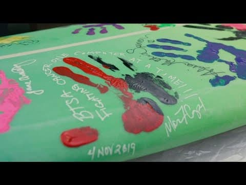 Surf board auctioned for $60K, surfer donates proceeds to fight cancer