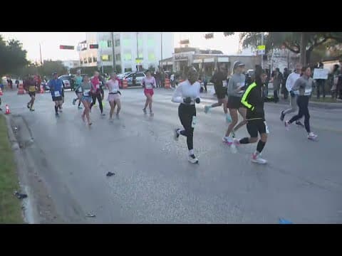 Runners try to stay warm during Chevron Houston Marathon