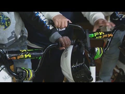 Elementary school students get surprised with helmets and bikes