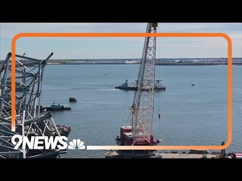 Crews removing containers from ship in Baltimore