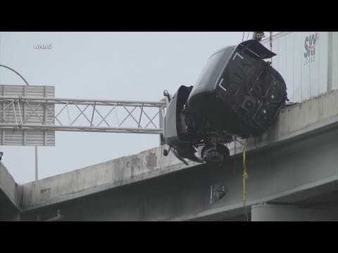 Truck driver calls 911 while dangling off a bridge