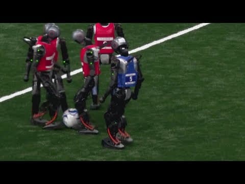 Robots play soccer during World Humanoid Robot Games in China