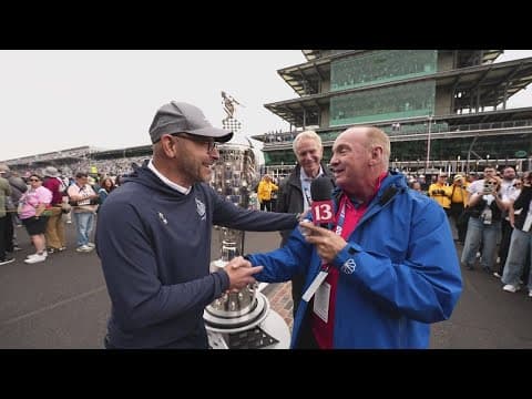 Chuck Lofton receives mini Borg-Warner Trophy at the Indy 500 for his retirement