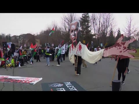 Pro Palestinian protesters gather outside the home of US Defense Secretary Lloyd Austin on Christmas