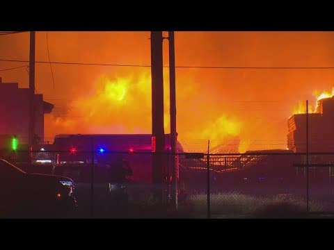 Dallas fire crews working to put out a large fire near Dallas Love Field