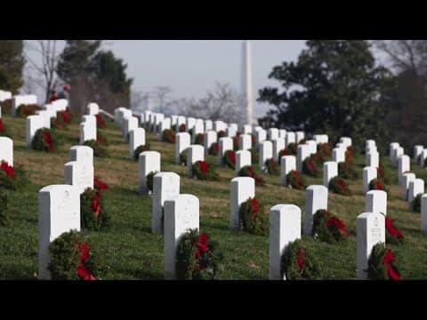 Volunteers lay wreaths at Arlington National Cemetery to honor veterans
