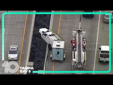Truck's front-end hangs over Sunshine Skyway Bridge barrier after crash