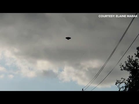 Wind appears to blow patio umbrella through the air