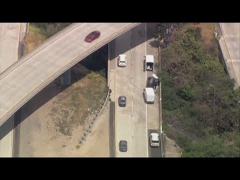 Overturned truck spills bag of cement off of I-805, kills passenger in car below