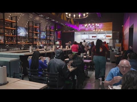 Customers brave the rain on the grand opening of Shaq's new restaurant in North Texas