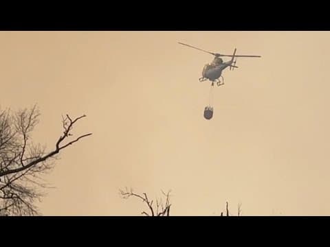 Texas firefighters use helicopters to dump water on Pauline Road fire