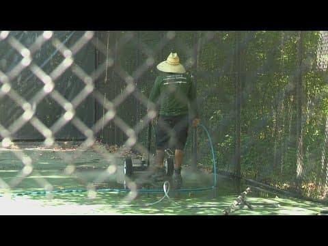 Crews begin to power wash the pickleball courts in Annandale, Virginia