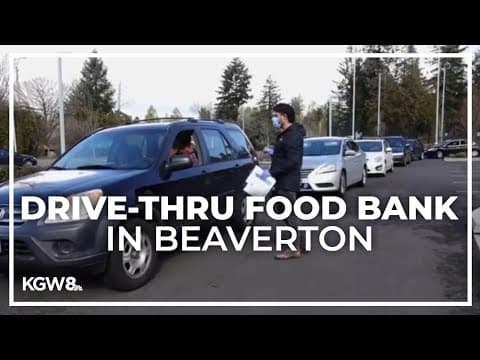 Families receive food from drive-thru food bank in Beaverton