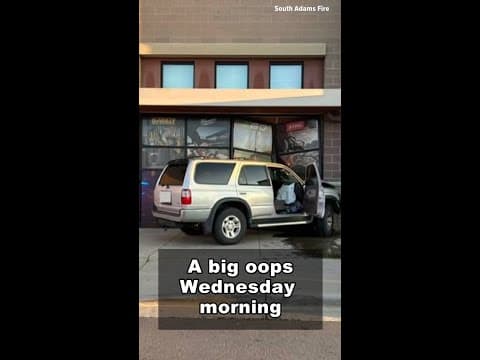 SUV driver crashes into building